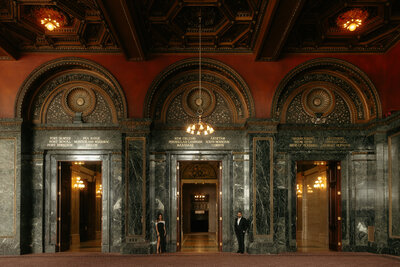 bride and groom sitting at a table in a garden