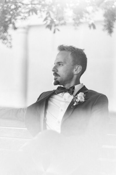 groom sitting while looking off to the left