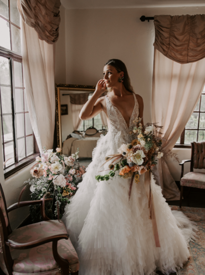 Wedding Hair and Makeup Orlando | Luxury Bridal Hair and Makeup Services in Central Florida Beauty Brigade | Bride wearing a down hairstyle with rustic florals