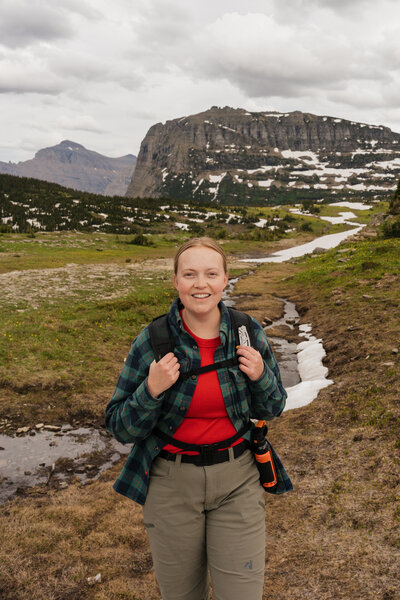 Glacier National Park Elopement Photographer posing at Logan Pass