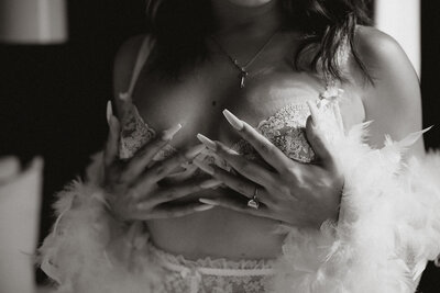 woman in white lingerie covering her breasts with her hands