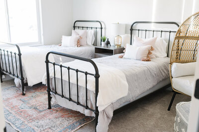 Twin beds and bedside cabinet arranged for interior design showcase in Utah.