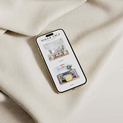 iPhone mockup of Maggie Cruz Home Landing Page with textile background