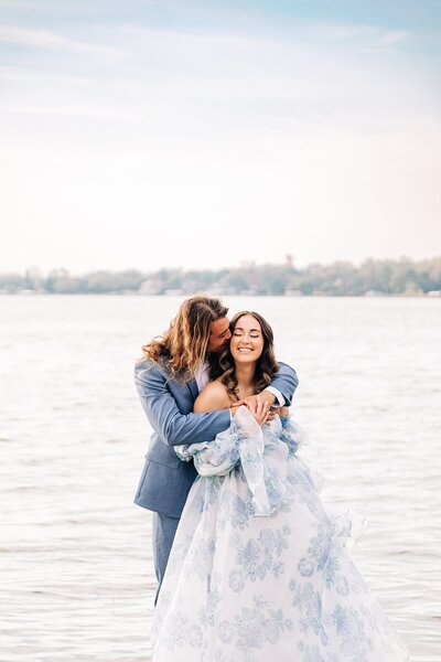 Newlywed couple posing on dock at Lakeside Inn in Mt. Dora