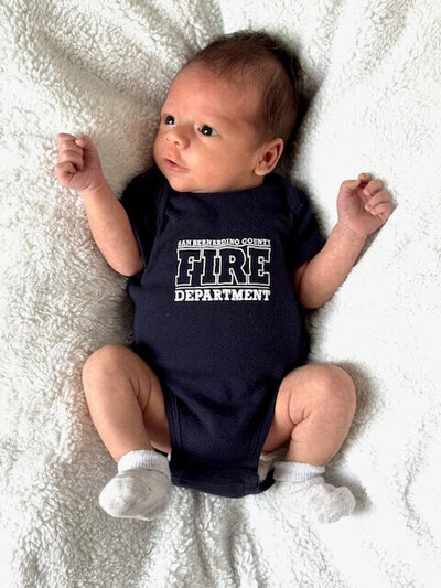 Screen printed firefighter onesie with department logo