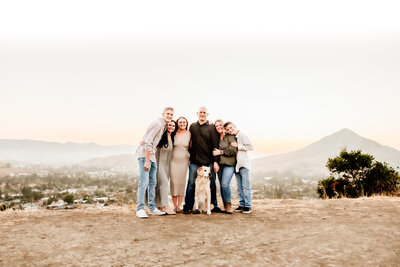 Family of 6 with their dog at sunset on Bishop's peak hill