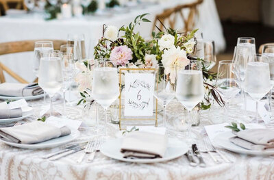 Luxury wedding table with utensils, wine glasses and floral centerpiece