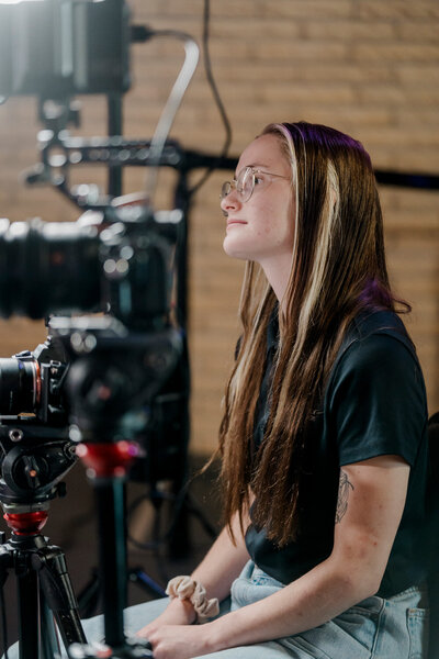 storyteller studios team member payton mccabe interviews a subject from behind the camera