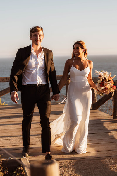 bride and groom walking on sidewalk