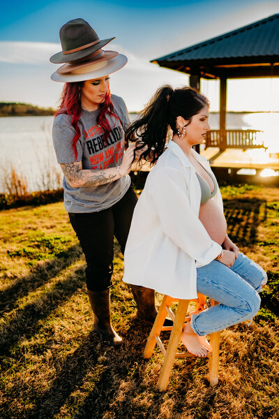 HMUA fixing hair for maternity photos at lake peigneur in new Iberia, la