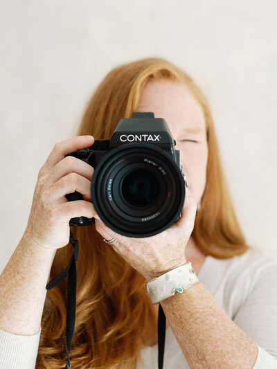 Headshot of Santa Fe Wedding Photographer Coryn Kiefer owner of Coryn Kiefer Photography with Contax Film Camera