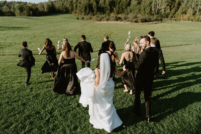 bride in strapless gown in front of earthy green floral installation