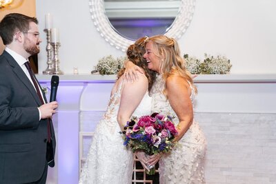 bride giving mom flowers on wedding day at saphire estate in Sharon, MA