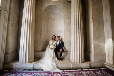 Catholic Bride and groom pose for photos near Washington DC monument after their wedding Mass.