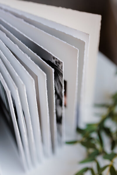 The thick deckled pages of a family heirloom album from Sarah & Ben Photography