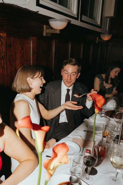 groom feeding bride at elopement party shot by Elsie Goodman Photography | NYC Elopement Packages