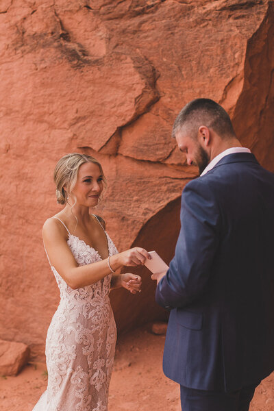 bride and groom embrace after elopement ceremony in las vegas desert