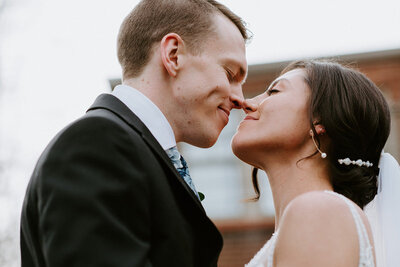 bride and groom lean in for a kiss