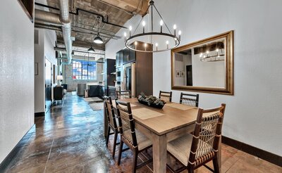 Dining room with seating for six in this three-bedroom, two-bathroom vacation rental condo in the historic Behrens building in downtown Waco, TX.