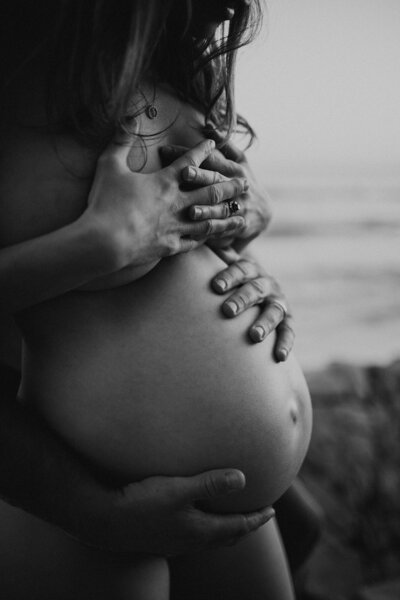 moody black and white beach maternity photography
