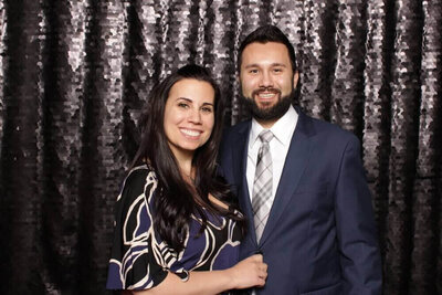 man and women posing in formalwear at a photo booth rental in West Chester