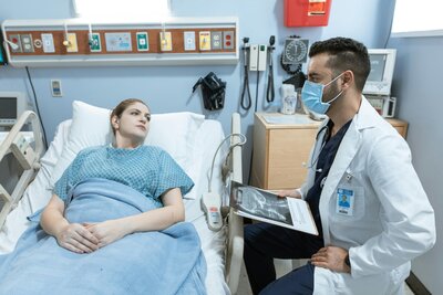 doctor at bedside with patient