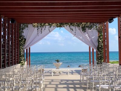 Outdoor wedding ceremony site with guests chairs and floral details
