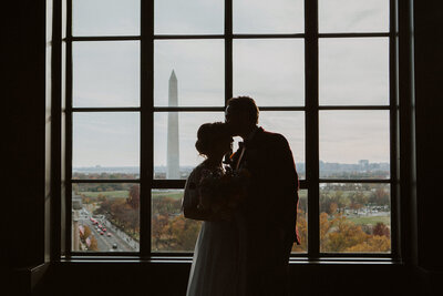 Bride and Groom pose in Hotel Washington wedding with the washington monument in the background