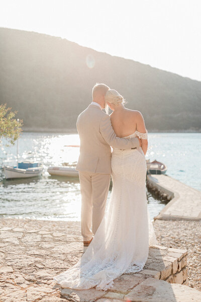 Couple on an Ionian beach at golden hour during their romantic destination wedding.