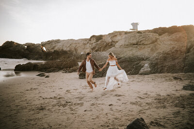 bride and groom walking on the beach