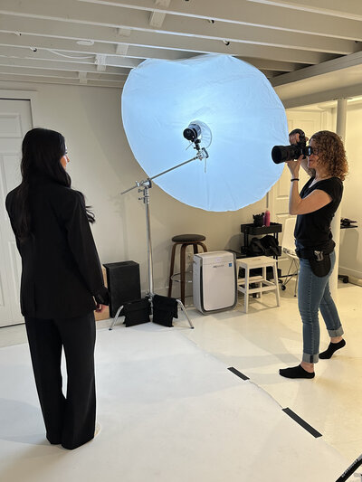 Behind-the-scenes image of a personal branding session in a Northville studio, featuring a business owner preparing for headshots.