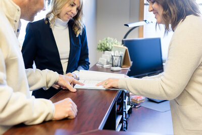 Heather showing client where to sign their tax return