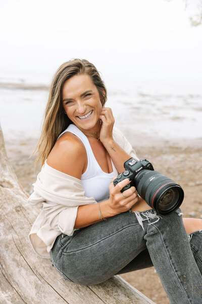 A woman holds a coffee mug in her hand and the other hand rests on her chin