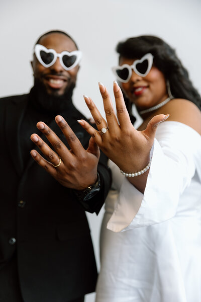 Couple showing their rings.