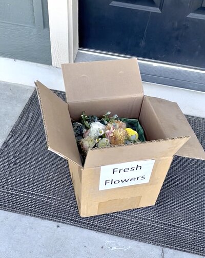 bride with her bridesmaids holding light pink rose bouquets outside the Logan LDS temple