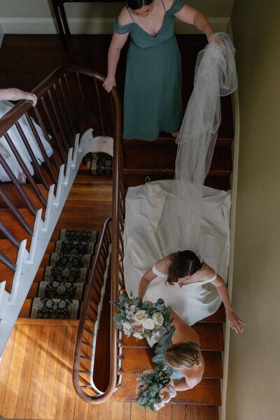Bride going down the stairs at Elkridge Furnace Inn in Maryland