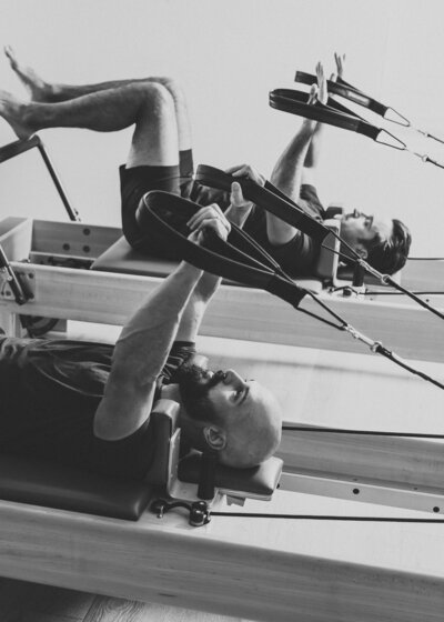 Two women on Pilates reformers