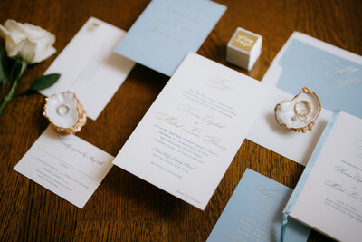 classic white and blue wedding invitation flatlay