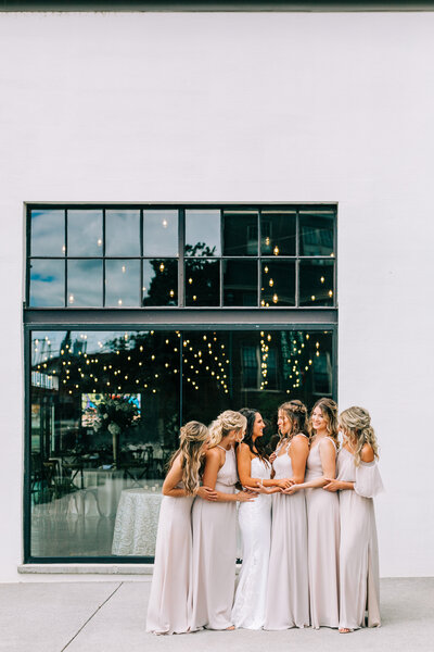 bride and bridesmaids smile at eachother winx photo tennessee wedding photographer