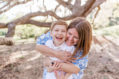 Mother and son laugh together during family photo shoot at Philippe Park in Safety Harbor, FL