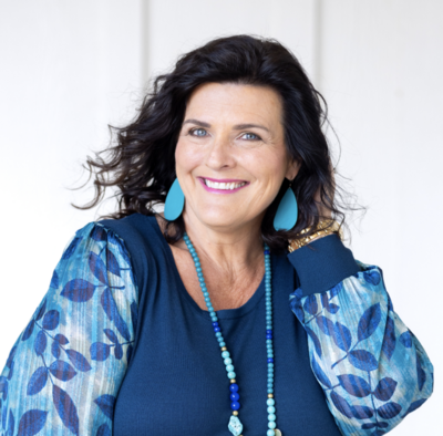 woman in blue smiling at camera