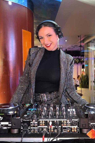 Female DJ in corporate attire DJ for a corporate event