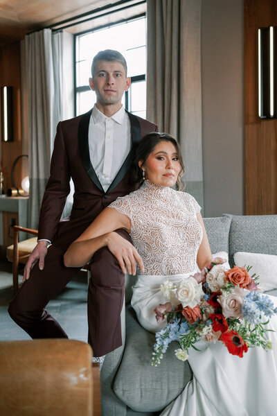 bride and groom sitting regally on wedding day