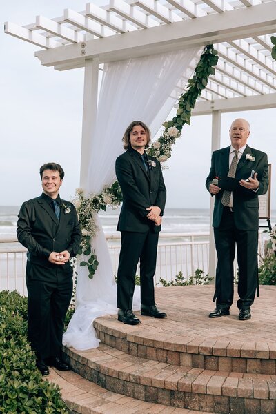 grooms gets emotional while watching his bride walk down the aisle