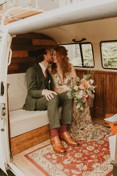 Bride & groom kiss in the back of a restored vintage van on their wedding day at The Lodges in Vashon, Washington