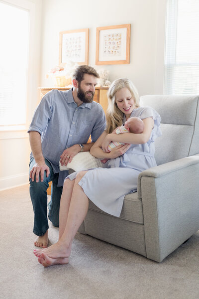 New parents hold their newborn baby during a NJ photo session.