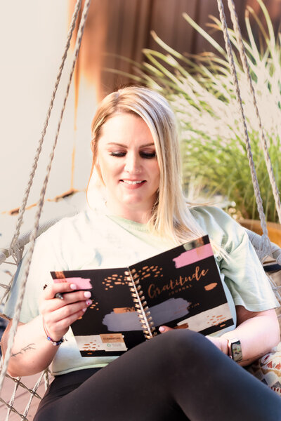 life coach sit with a journal in her hands