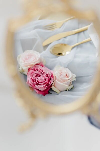 Roses in blush and pink captured on a mirror designed by ECLAT Destination Weddings Vienna