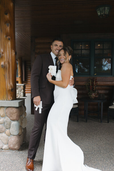 Bride and groom pose with vow books after exchanging private vows on their intimate wedding day in northern Minnesota. Captured by a Minnesota Wedding and Elopement Photographer specializing in couples looking for an intimate, documentary style wedding day coverage. 