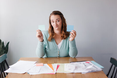 Emily organizing an array of papers with post it notes